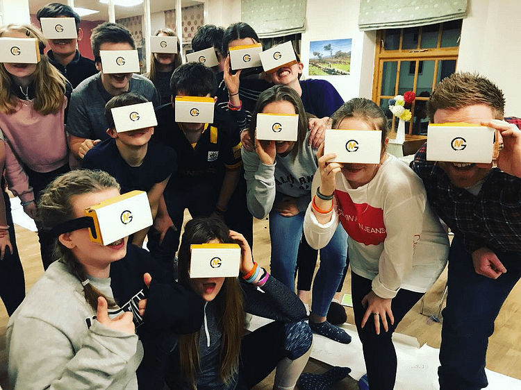 A youth group all wearing cardboard VR headsets